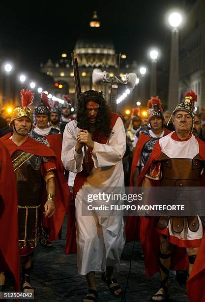 People reenact the way of the cross by Jesus Christ on Via della Conciliazione leading from St.Peter's Basilica at the Vaticano in Rome on February...