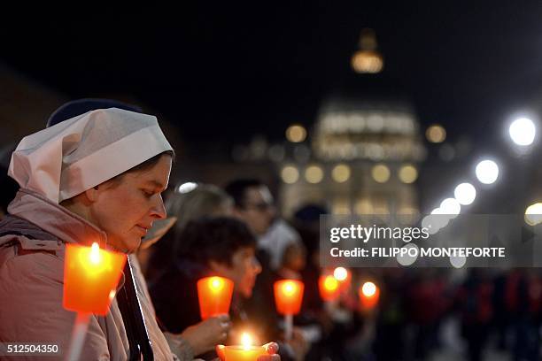 Faithfulls follow the way of the cross by Jesus Christ on Via della Conciliazione leading from St.Peter's Basilica at the Vaticano in Rome on...