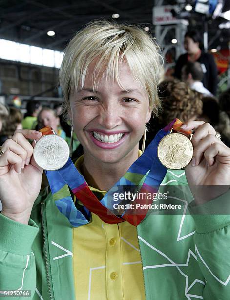 Swimmer Brooke Hanson poses with her medals during the Australian Olympic team homecoming welcome at the Qantas Jetbase September 1, 2004 in Sydney,...
