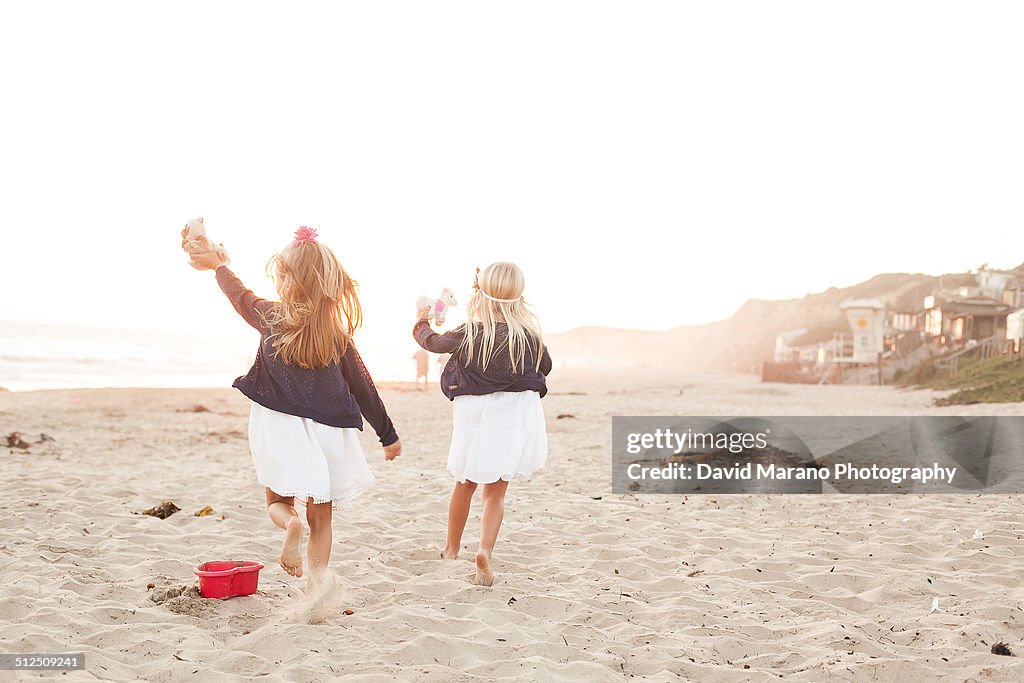 Two kids running on beach