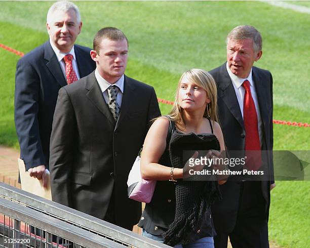 Manager Sir Alex Ferguson, Wayne Rooney of Mancester United with fiancee Coleen McLoughlin and Agent Paul Stretford after the press conference to...