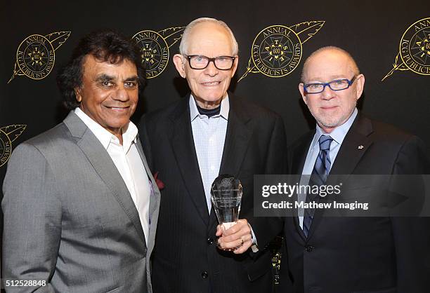 Singer Johnny Mathis, lyricist Alan Bergman, winner of the special award of merit, and ICG President Steven Poster pose backstage at the 53rd Annual...