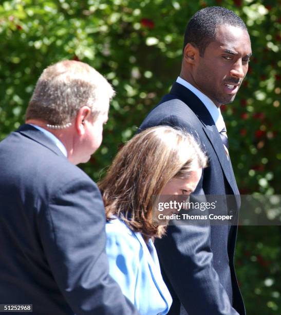 Kobe Bryant looks at his attorney Pamela Mackey and his security guard as he leaves the Eagle County Justice Center after the fourth day of jury...