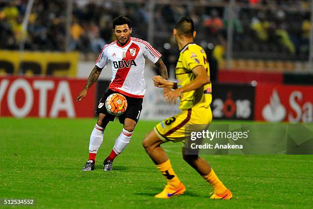 Tabaré Viudez of River Plate fights for the ball with Luigi Erazo of Trujillanos during a group stage match between Trujillanos and River Plate as...