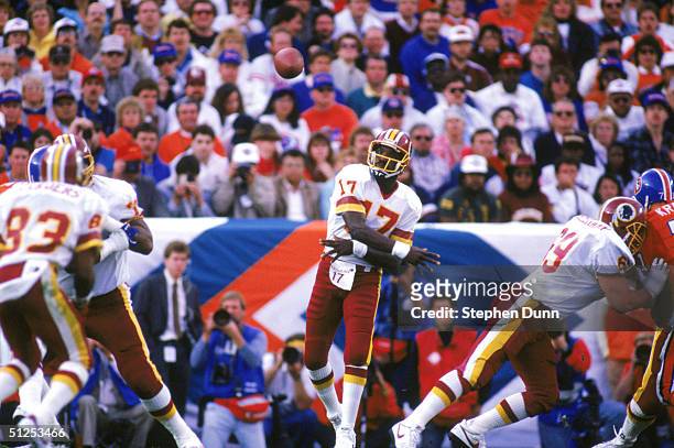 Quarterback Doug Williams of the Washington Redskins passes during Super Bowl XXII against the Denver Broncos at Jack Murphy Stadium on January 31,...