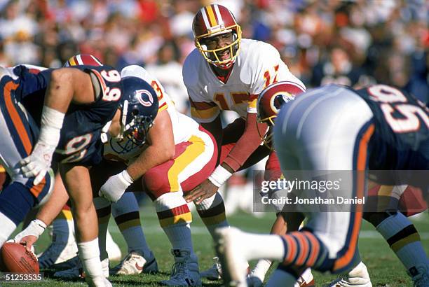 Doug Williams of the Washington Redskins calls an adible at the line of scrimmage during the 1988 NFL season game against the Chicago Bears at...