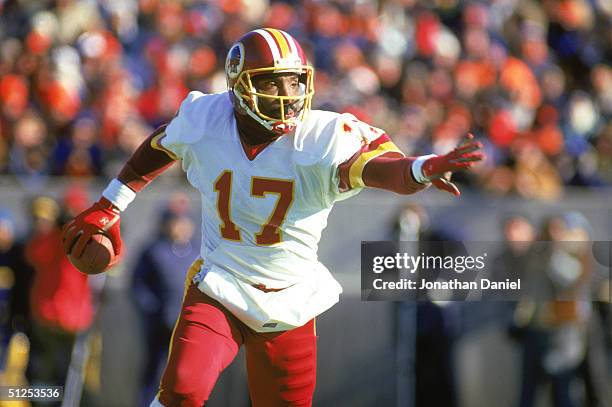 Doug Williams of the Washington Redskins scrambles with the ball during a 1987 NFL season game.