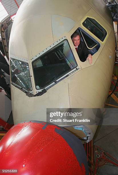 German President Horst Koehler sits in the pilots seat of an Airbus A319 during his visit to the Airbus factory, September 1, 2004 in Hamburg,...