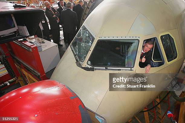 German President Horst Koehler sits in the pilots seat of an Airbus A319 during his visit to the Airbus factory, September 1, 2004 in Hamburg,...