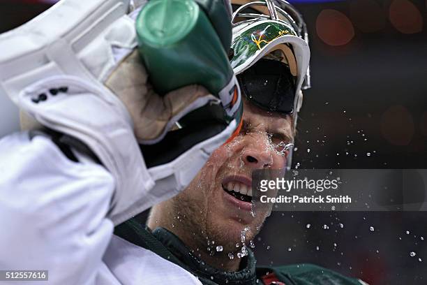 Goalie Darcy Kuemper of the Minnesota Wild splashes water on his face against the Washington Capitals during the second period at Verizon Center on...