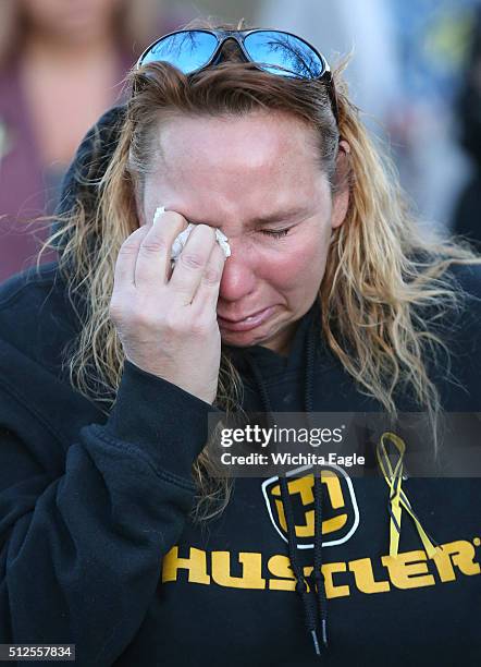 Shelly Schale cries during a candlelight vigil at Heritage Park in Hesston, Kan., on Friday, Feb. 26, 2016. Cedric Ford, an Excel Industries...