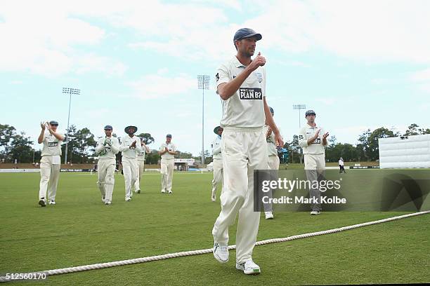 Trent Copeland of the Blues ackowledges the crowd as he leaves the field after taking five wickets during day three of the Sheffield Shield match...