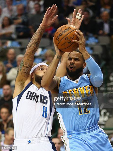 Augustin of the Denver Nuggets is fouled by Deron Williams of the Dallas Mavericks during the first half at American Airlines Center on February 26,...