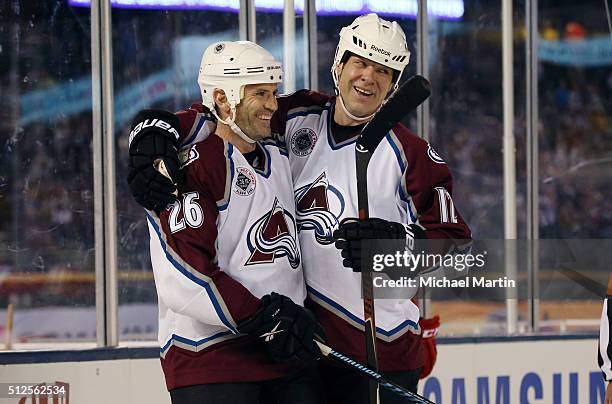 Stephane Yelle of the Colorado Avalanche Alumni team celebrates a goal against the Red Wings Alumni team with teammate Chris Simon at the 2016 Coors...
