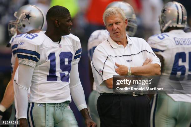 Head coach Bill Parcells of the Dallas Cowboys talks to Keyshawn Johnson on the sideline during warmups before the preseason NFL game against the...