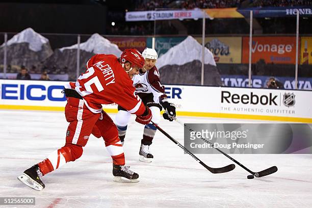Darren McCarty of the Detroit Red Wings takes a shot against Rob Blake of the Colorado Avalanche during the 2016 Coors Light Stadium Series Alumni...