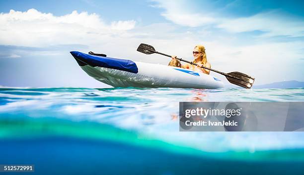 family kayaking on sea, water level view - sea kayak stock pictures, royalty-free photos & images