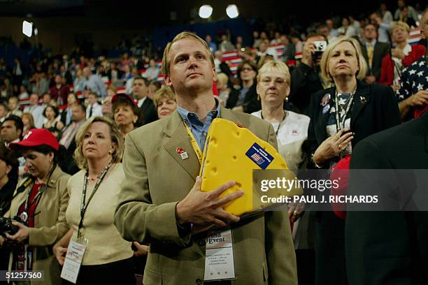 United States: An unidentified delegate holds his "cheesehead" hat over his heart during the National Anthem at the Republican National Convention at...