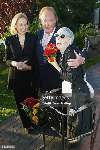 Rene Kollo and Beatrice Bouquet arrive at the restaurant variety show "Pomp, Duck and Circumstance" on the premiere night September 2, 2004 in...