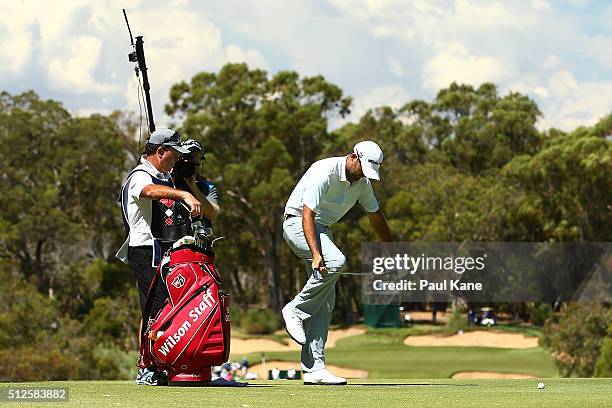 Rhein Gibson of Australia bends his iron back into shape after playing his second shot from the rough on the 6th hole during day three of the 2016...