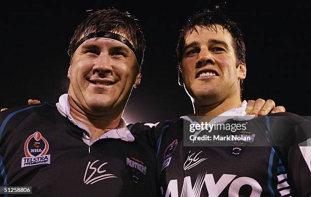 Martin Lang and Ryan Girdler of the Panthers bid farewell to their home crowd after the round 26 NRL match between the Penrith Panthers and the...