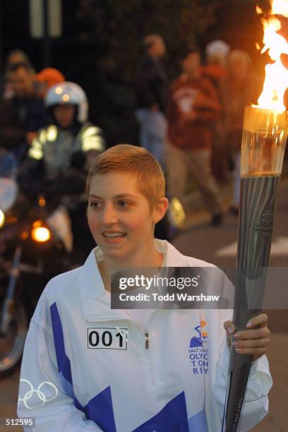 Torchbearer Kerri Costello carries the Olympic Flame during the 2002 Salt Lake Olympic Torch Relay in Memphis, Tennessee. DIGITAL IMAGE. Mandatory...