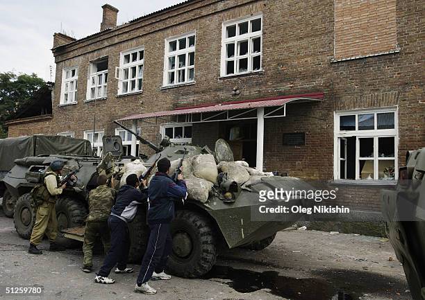 Armed soldiers cover the area after special forces stormed a school seized by Chechen separatists on September 3, 2004 in the town of Beslan, Russia....