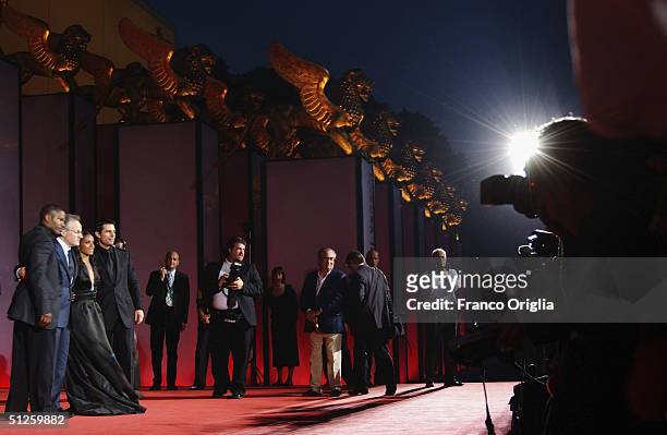 Actor Tom Cruise, actress Jada Pinkett Smith , director Michael Mann and actor Jamie Foxx pose for photographers as they arrive for the "Collateral"...