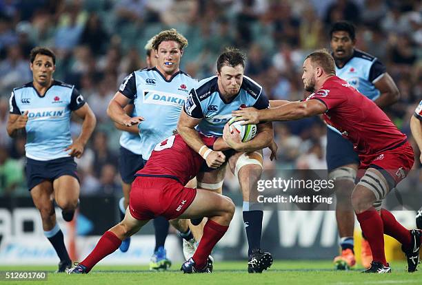 Jed Holloway of the Waratahs takes on the defence during the round one Super Rugby match between the Waratahs and the Reds at Allianz Stadium on...