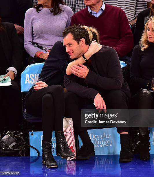 Phillipa Coan and Jude Law attend the Orlando Magic vs New York Knicks game at Madison Square Garden on February 26, 2016 in New York City.