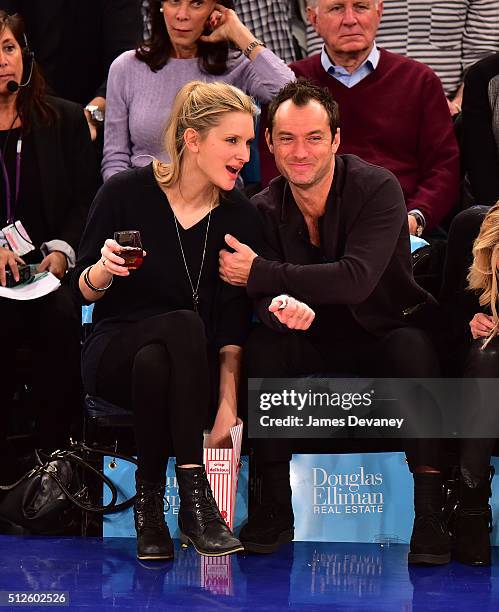 Phillipa Coan and Jude Law attend the Orlando Magic vs New York Knicks game at Madison Square Garden on February 26, 2016 in New York City.