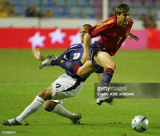 Spaniard Joaquin vies with Quasihe of Scotland in a friendly match in Ciudad de Valencia Stadium in Valencia 03 September 2004.