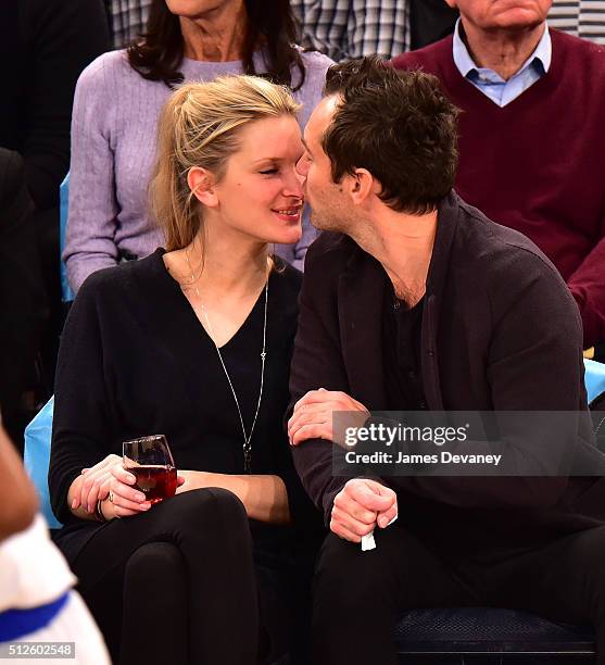 Phillipa Coan and Jude Law attend the Orlando Magic vs New York Knicks game at Madison Square Garden on February 26, 2016 in New York City.