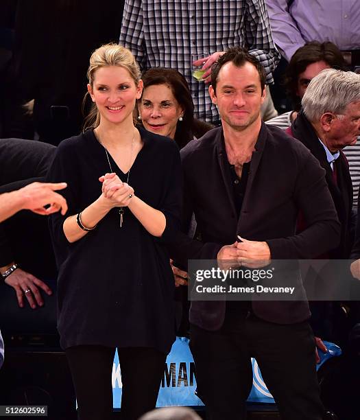 Phillipa Coan and Jude Law attend the Orlando Magic vs New York Knicks game at Madison Square Garden on February 26, 2016 in New York City.