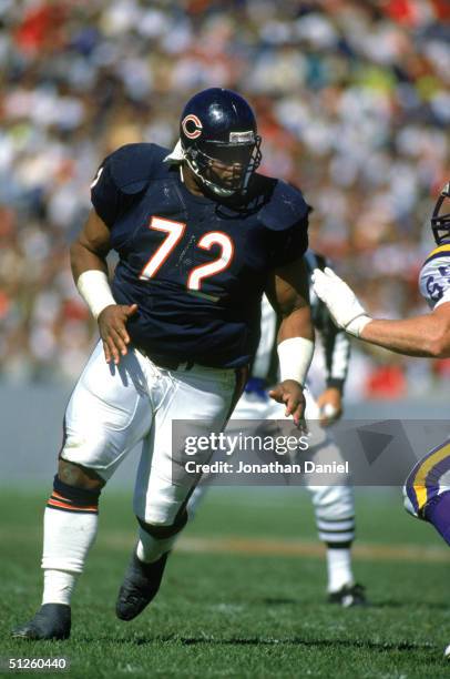 William Perry of the Chicago Bears runs through the Minnesota Vikings defense during a game at the Soldier Field on September 23, 1990 in Chicago,...