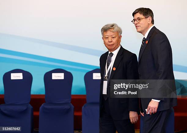 Jin Liqun , President of the Asian Infrastructure Investment Bank , walks with US Treasury Secretary Jacob Lew after a family photo of G20 Finance...