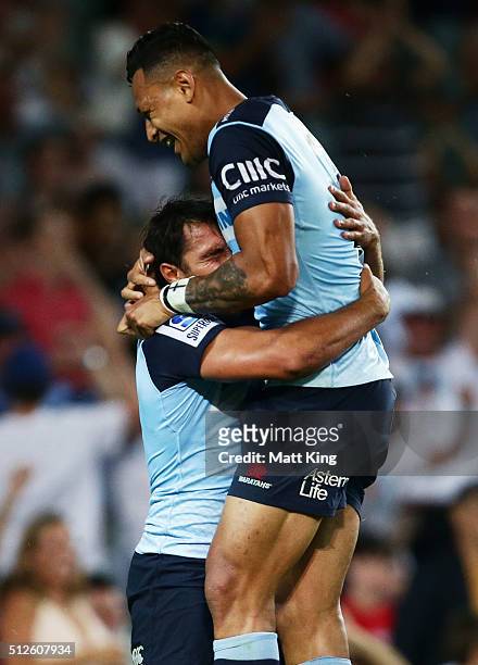 Nick Phipps of the Waratahs celebrates with Israel Folau after scoring a try during the round one Super Rugby match between the Waratahs and the Reds...