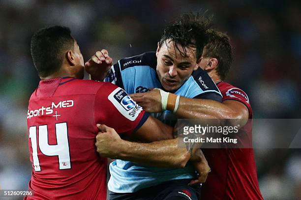 Zac Guildford of the Waratahs is tackled during the round one Super Rugby match between the Waratahs and the Reds at Allianz Stadium on February 27,...