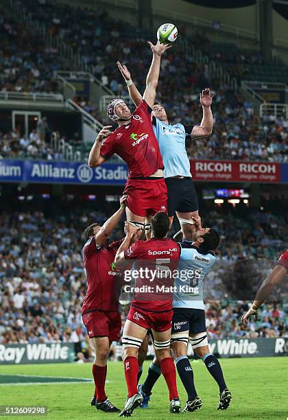 Cadeyrn Neville of the Reds and Jed Holloway of the Waratahs jump at the lineout during the round one Super Rugby match between the Waratahs and the...