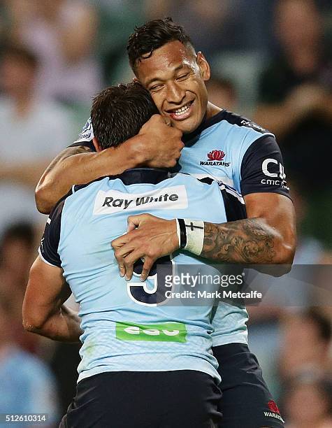 Nick Phipps of the Waratahs celebrates scoring a try with team mate Israel Folau during the round one Super Rugby match between the Waratahs and the...