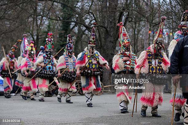 Participants dressed in colourful hand-made costumes and wearing masks attend Masquerade Festival "Kukerlandia" in Yambol town of Bulgaria on...