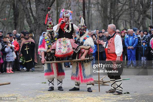 Participants dressed in colourful hand-made costumes and wearing masks attend Masquerade Festival "Kukerlandia" in Yambol town of Bulgaria on...