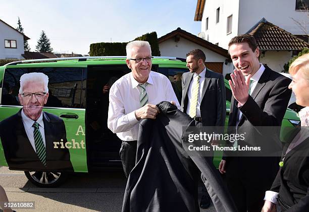 Winfried Kretschmann , Governor of Baden-Wuerttemberg and member of the German Greens Party , and Bennet Mueller arrive a state election campaign...