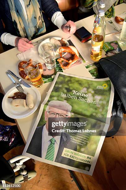 Supporters eat Bavarian veal sausage and drink beer while they wait for Winfried Kretschmann, Governor of Baden-Wuerttemberg and member of the German...