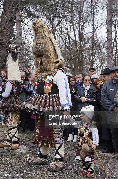 Participants dressed in colourful hand-made costumes and wearing masks attend Masquerade Festival "Kukerlandia" in Yambol town of Bulgaria on...