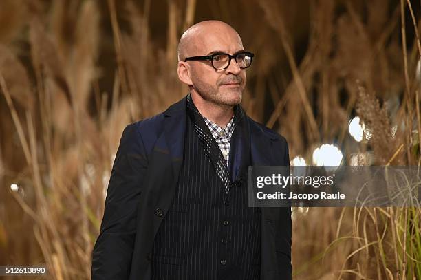 Designer Antonio Marras aknowledge the applause of the public after the Antonio Marras show during Milan Fashion Week Fall/Winter 2016/17 on February...