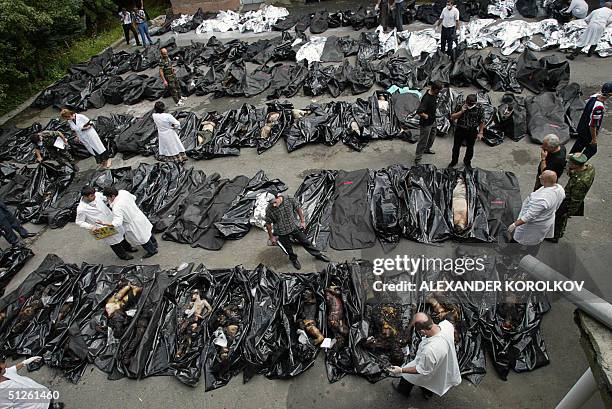 People look for relatives among the dead bodies of the Beslan hostage-taking drama victims at the morgue in Vladikavkz, North Ossetia, 04 September...
