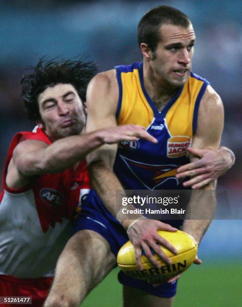 Chris Judd for West Coast is tackled by Brett Kirk for Sydney during the AFL Elimination Final Match between the Sydney Swans and the West Coast...
