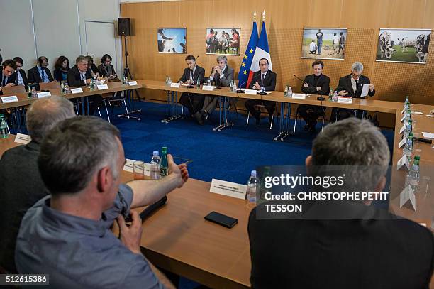 French President Francois Hollande and Agriculture Minister Stephane Le Foll attend a meeting with French agriculture unions as a part of his visit...