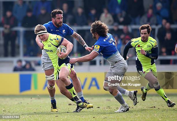 Ross Harrison of Sale Sharks is tackled by Jacques Burger of Saracens during the Aviva Premiership match between Sale Sharks and Saracens at AJ Bell...